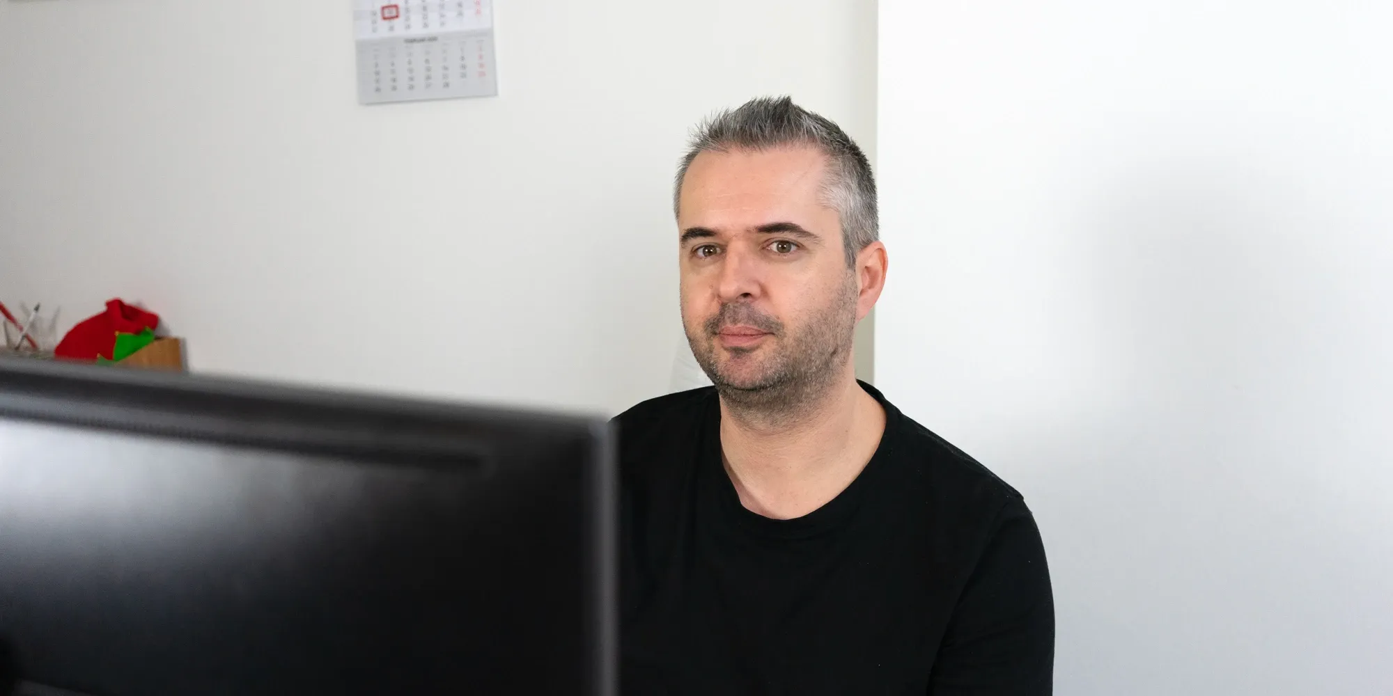 Backend lead working independently on a laptop in a modern workspace.