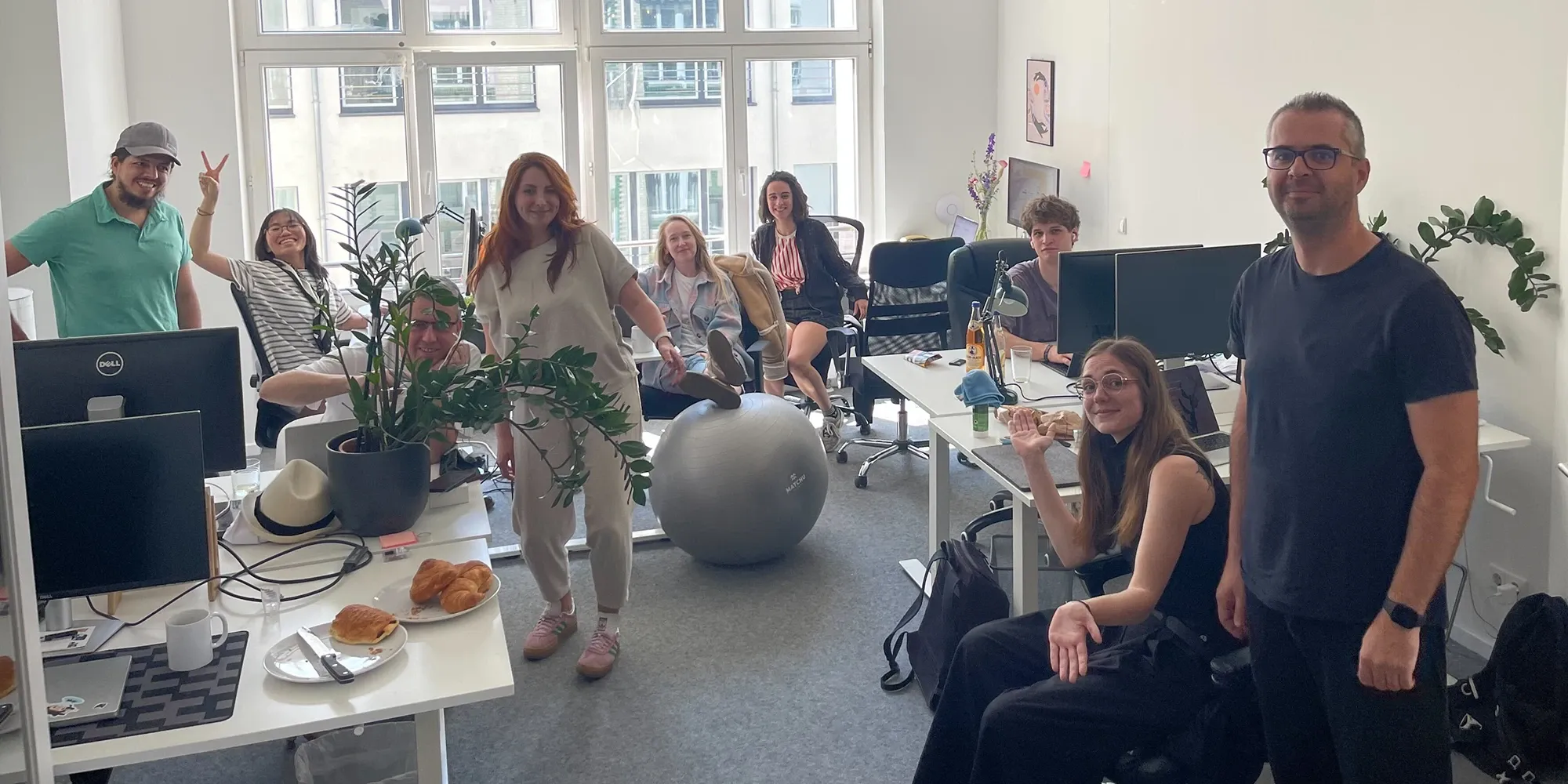 Backend lead with a large group of colleagues in the office.